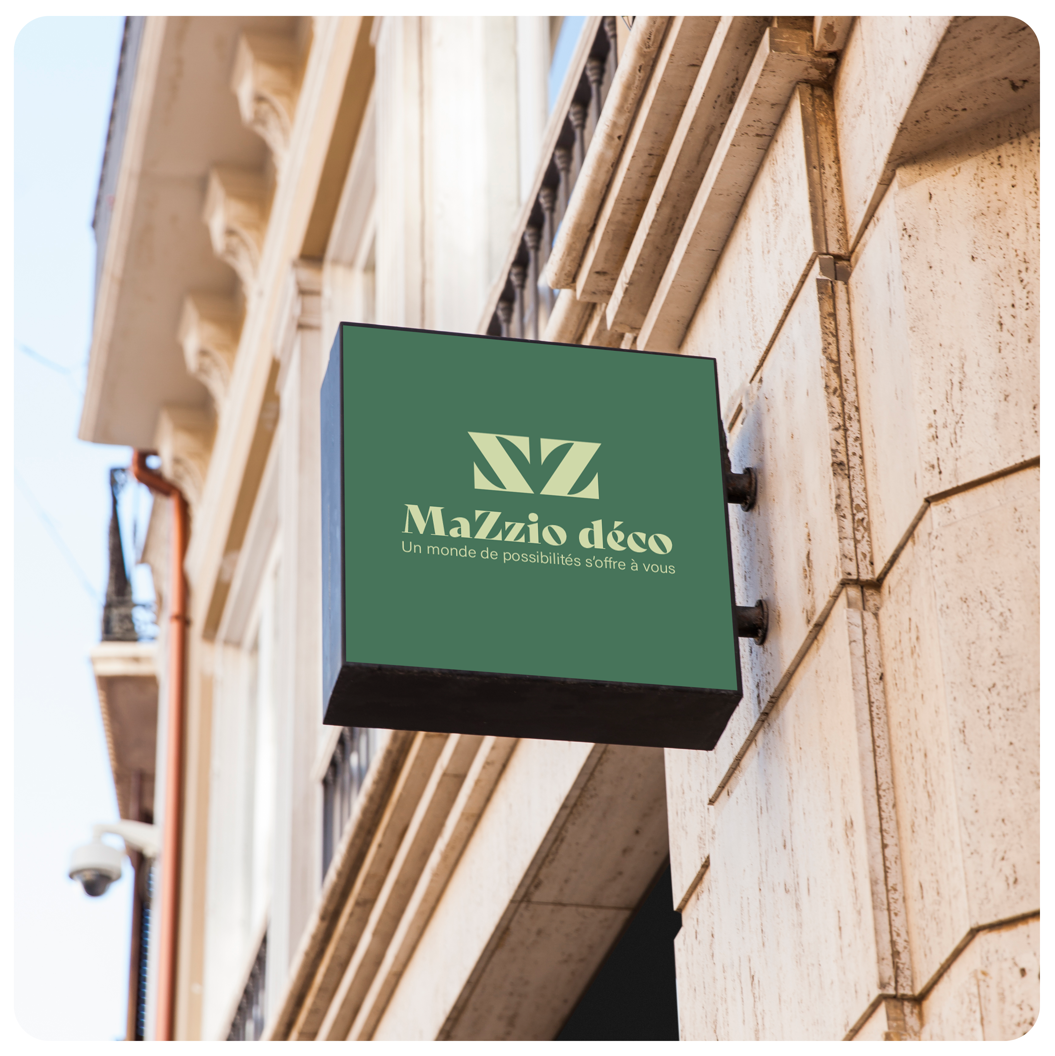 Enseigne drapeaux MaZzio déco posée sur un bâtiment en vieilles pierres style haussmannien .